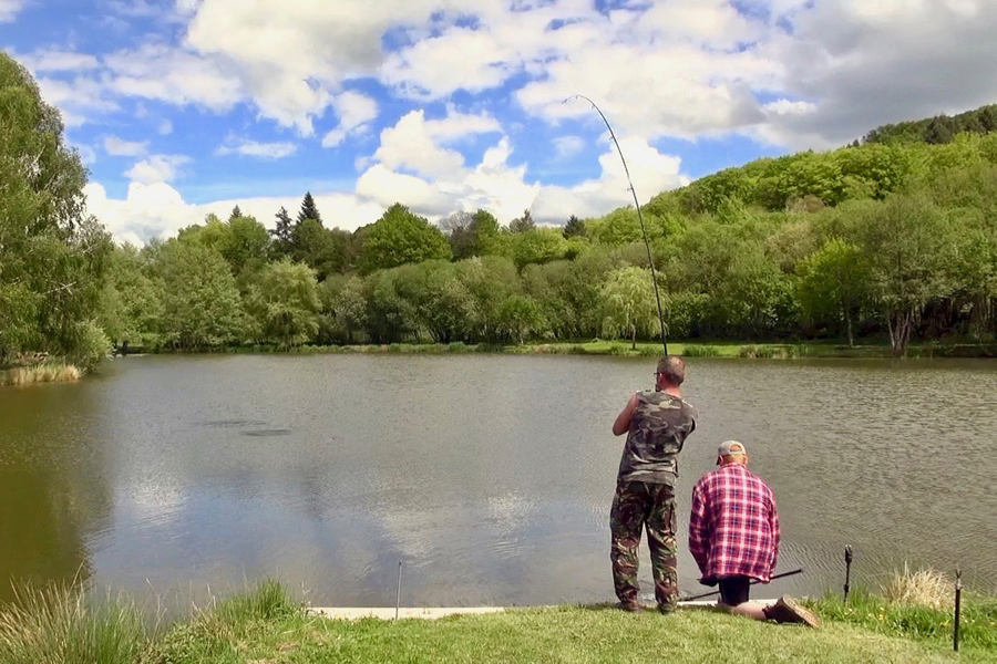 Anglers reeling in a catch at Etang de Azat-Chatenet lake in France