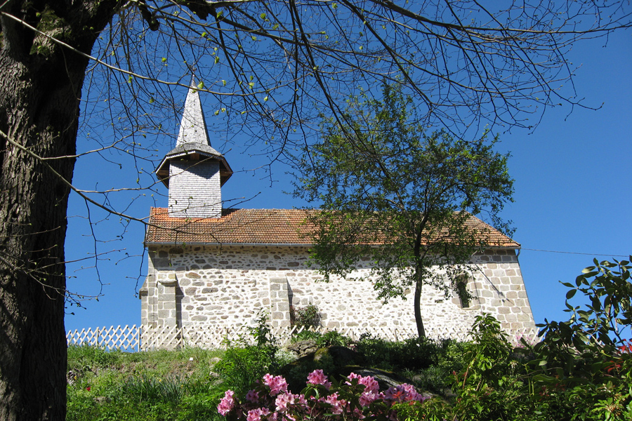 View of church at Etang de Azat-Chatenet fishing lake in France