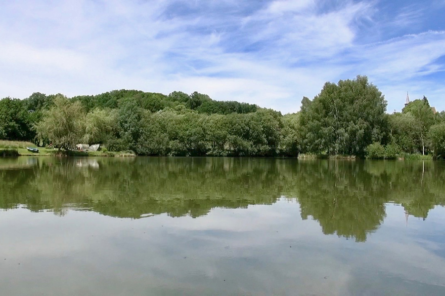 Bivvy anglers fishing for carp at Etang de Azat-Chatenet lake in France
